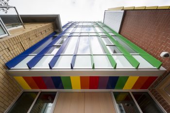 blue and green siding with glass and rainbow ceiling. 