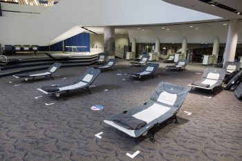 cots in the scarborough civic centre warming centre. Each bed has a blanket.