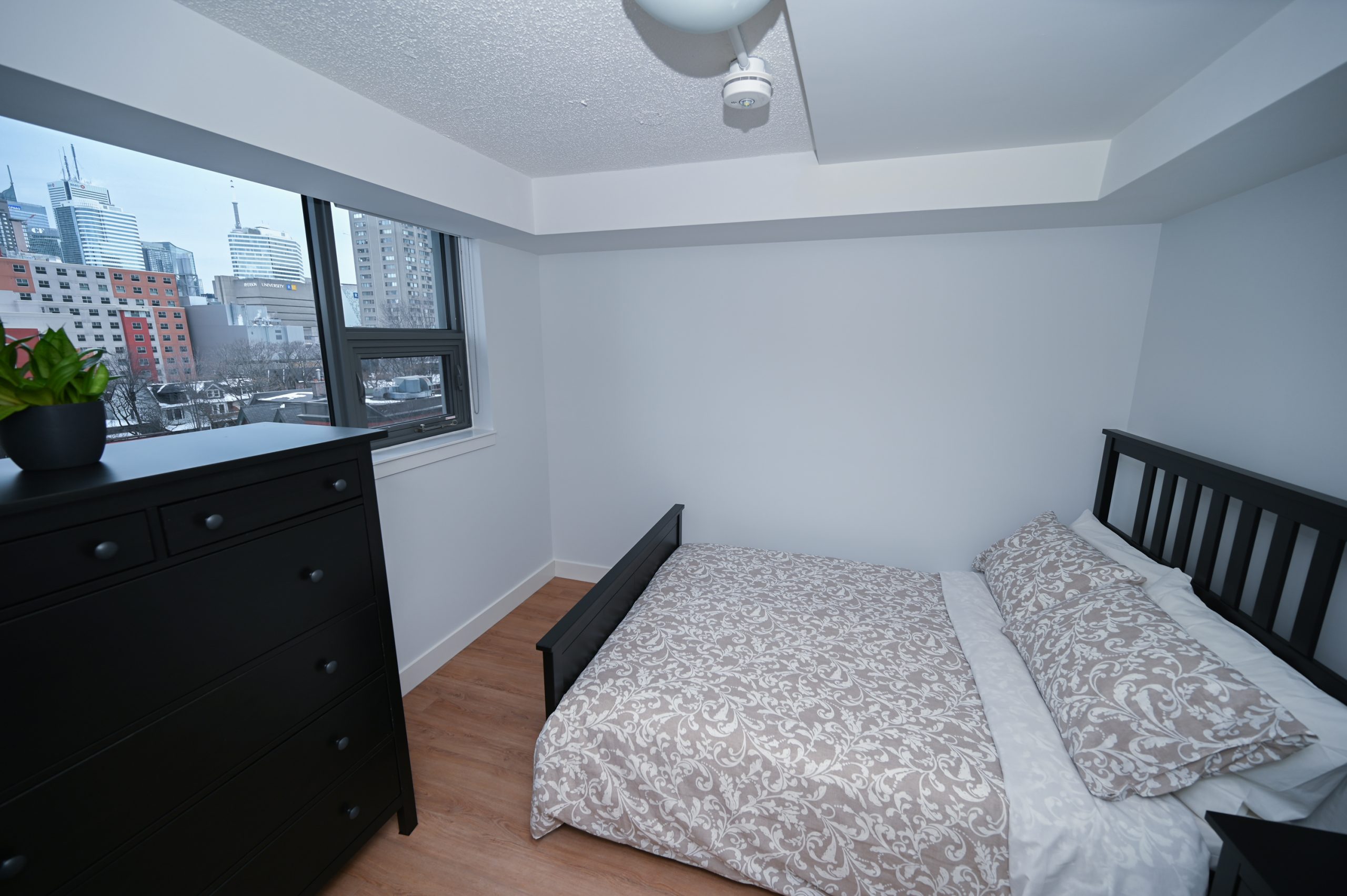 Bedroom with bed and dresser in 389 Church St.