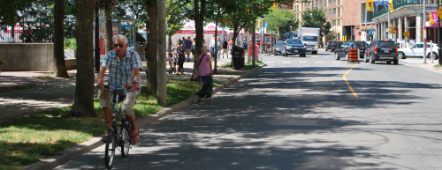 Senior riding bike along The Esplanade 