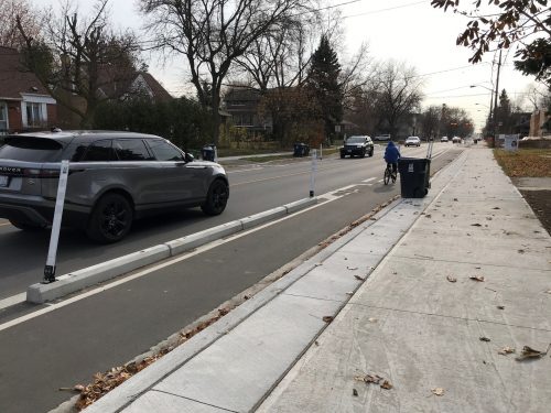 Protected bicycle lane on Willowdale Avenue with curbs and bollards