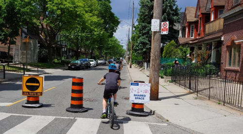 A group of people riding bikes on a Quiet Street in Toronto.