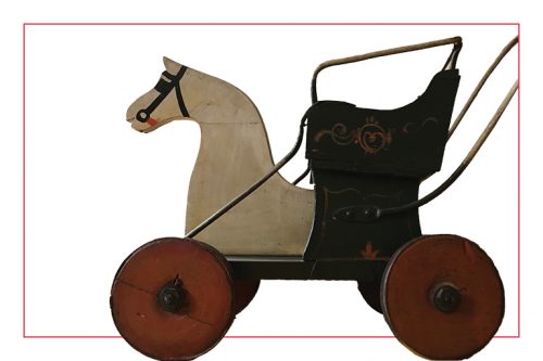 A wooden stroller with horse-drawn carriages typical of the period