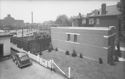 One story brick building with transformer yard in the backyard.