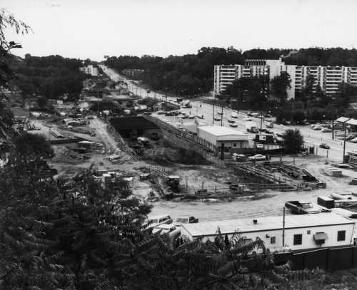 Site of excavation with workers' trailers. Far side of Yonge Street shows apartment buildings