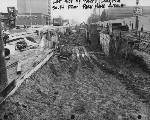 Large muddy trench excavated on Yonge Street.