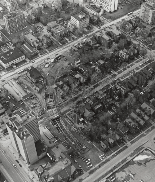 Aerial view showing construction of tunnel and surrounded by apartment buildings and houses