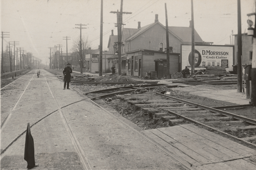 Long, curving lines of streetcar tracks cross two straight rows of tracks.