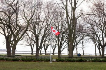 Image of a Canadian Flag that flew at Vimy Ridge, flying at half-mast at Coronation Park