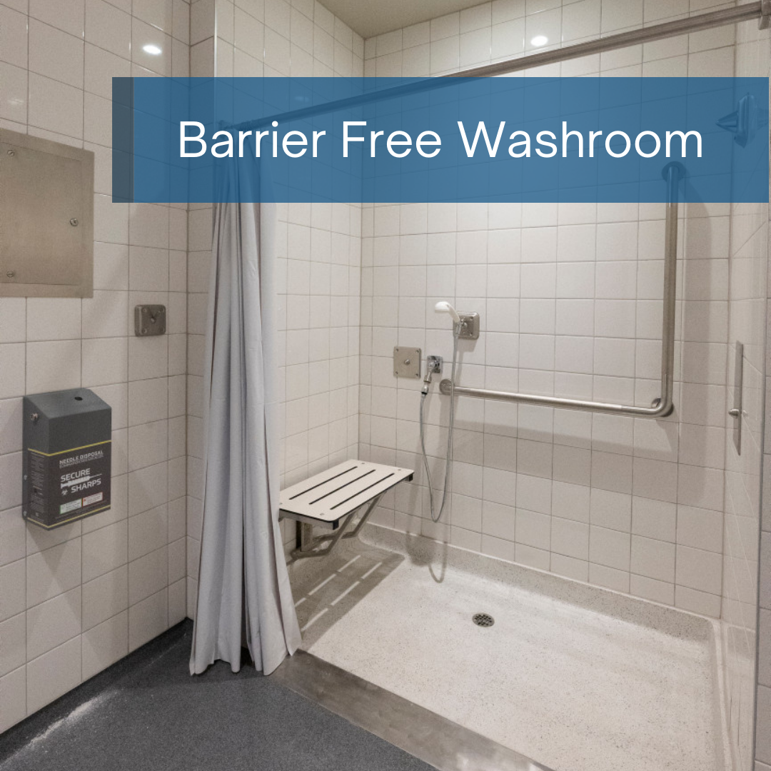 an accessible shower space with handles and sitting area