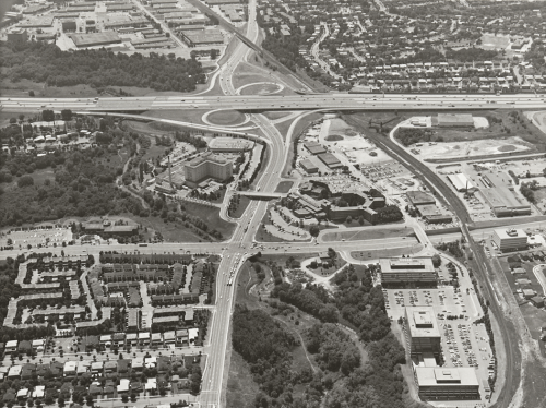 Major roadways and highway with subdivisions and hospital in the foreground.