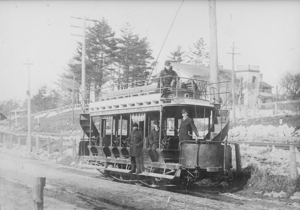 A double-decker streetcar with curving staircases at each end. 