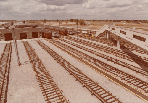 Elevated view looking over tracks in yard with G-subway cars and H-subway cars.