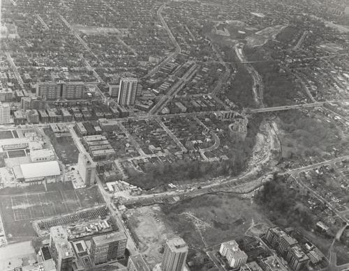 Excavation for subway tunnel through ravine showing sections under bridges with surrounding built up area.