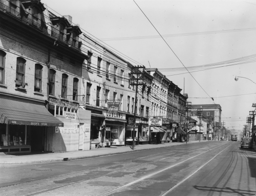 A line of three-storey brick buildings with stores on the first floor, including a Loblaws grocery.