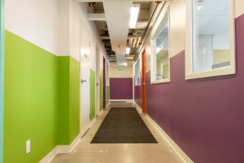 green and purple brightly lit hallway