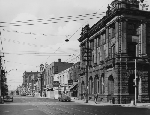 An imposing stone bank building on a streetcorner.