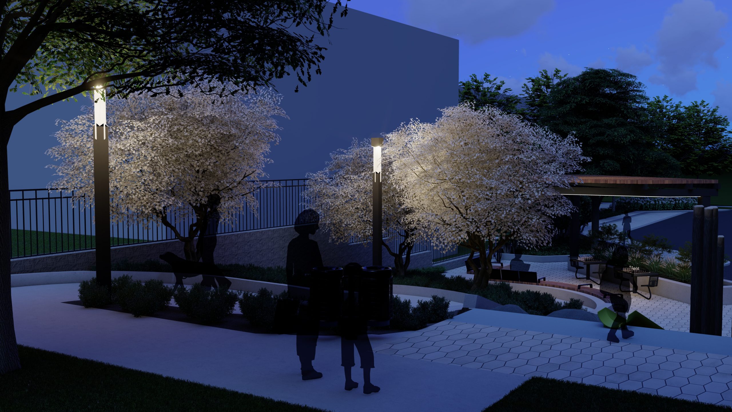 Perspective rendering of the revised concept design, providing a night time view of the new park looking southeast from the entrance at Glengarry Avenue. Pictured are park users sitting and walking throughout the park, light poles, and the shade structure in the background.