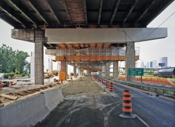Road under construction underneath elevated expressway.