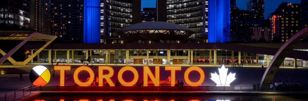 Toronto sign lit orange