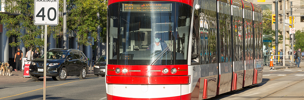 Streetcar travels along Queens Quay.