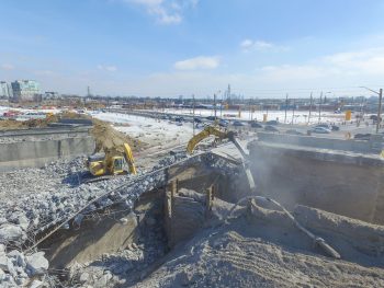 Construction vehicles demolish a bridge in Etobicoke Centre. 