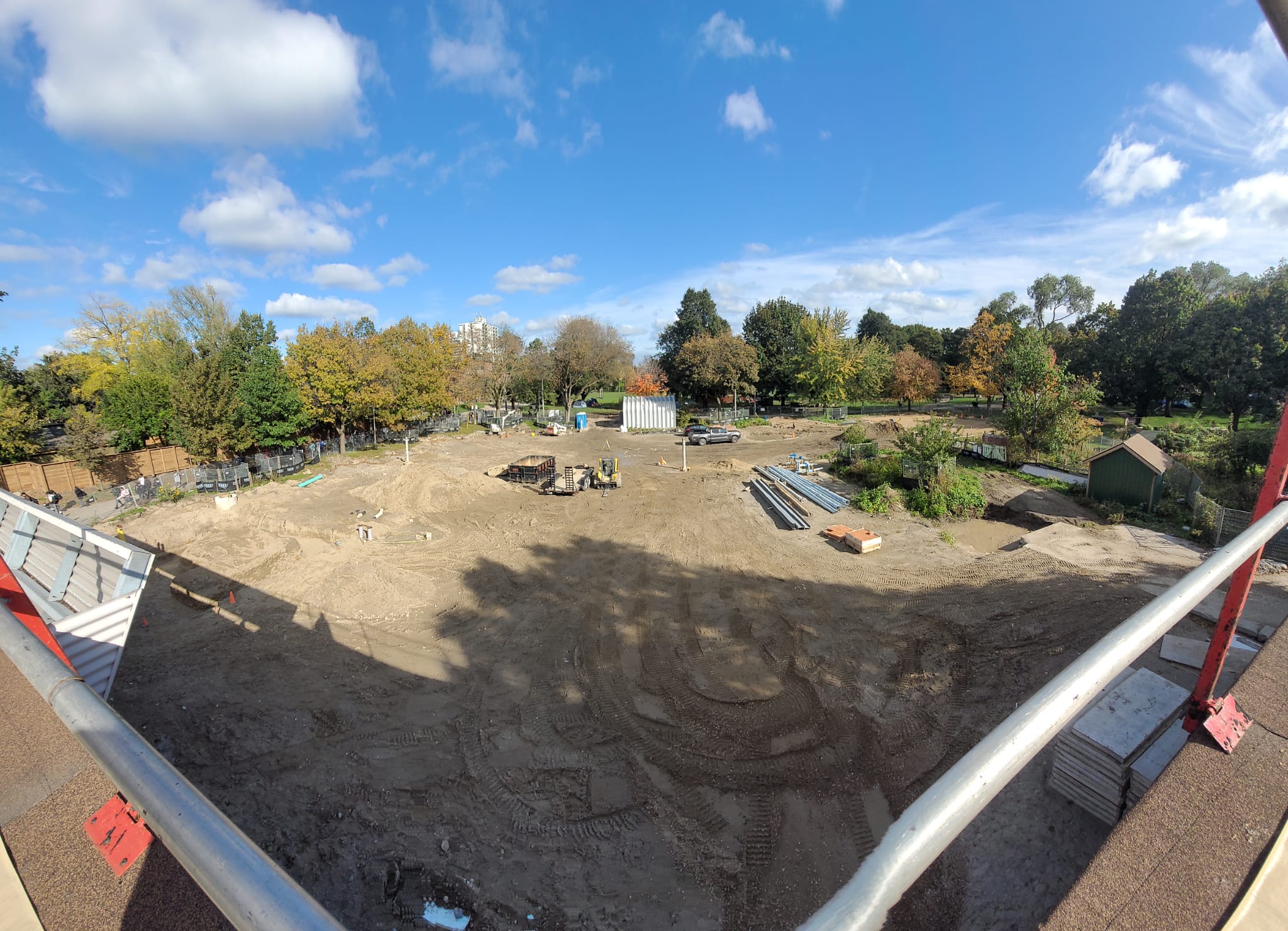 View east into Dufferin Grove Park, showing the worksite for the new Clubhouse including laying the foundation for the new Zamboni garage, installing the light poles for the rink and preparing the site for the new basketball court.