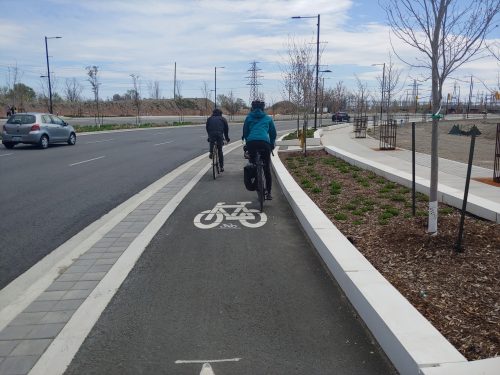 Photo of a raised cycle track with people cycling