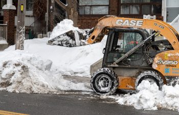 skid steer loader moves snow.