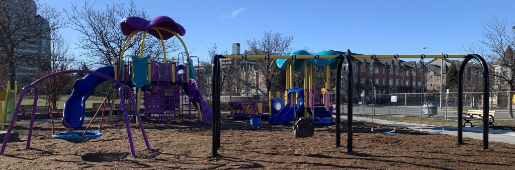 A photograph of Rosebank Park playground, completed in 2024. Swings are in the foreground, and junior and senior climbing equipment is in the background.