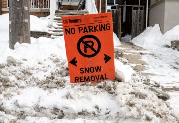 Orange, temporary no parking sign while snow removal takes place