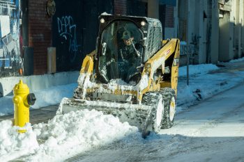 sidewalk plow clears Toronto street