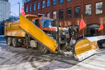 snow plow travels downtown