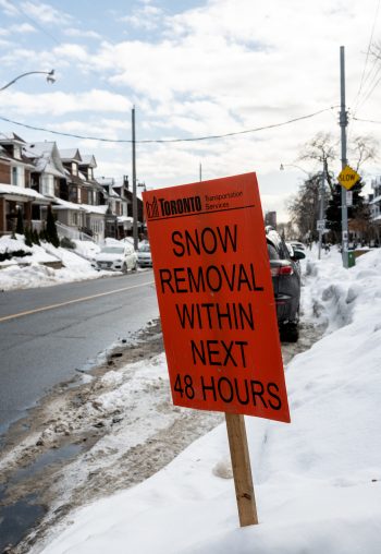 Orange temporary sign indicated that snow clearing will be completed in the next 48 hours.