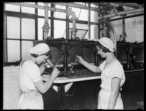 Photograph of factory workers testing jam
