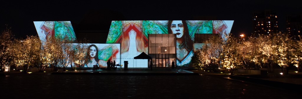 Aga Khan Museum at night with art projection lighting up side of the building