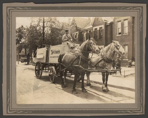 Man driving a horse-drawn delivery wagon