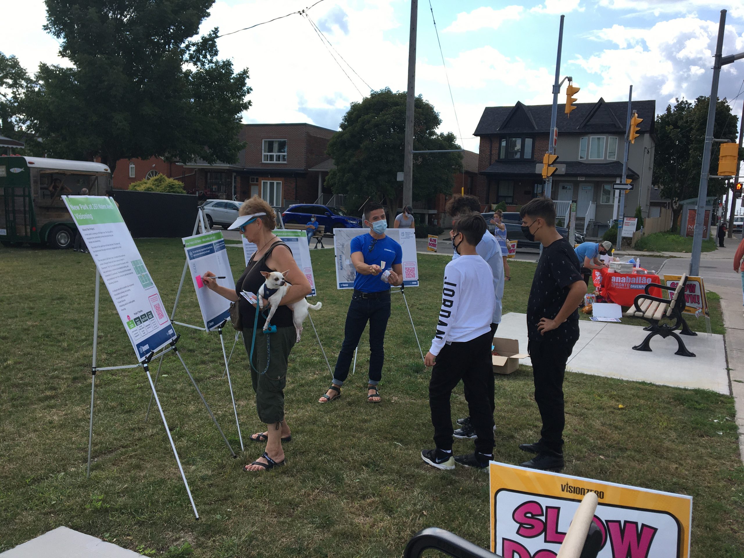 Pop-up participants stand infront of information boards at 261 Nairn Avenue.
