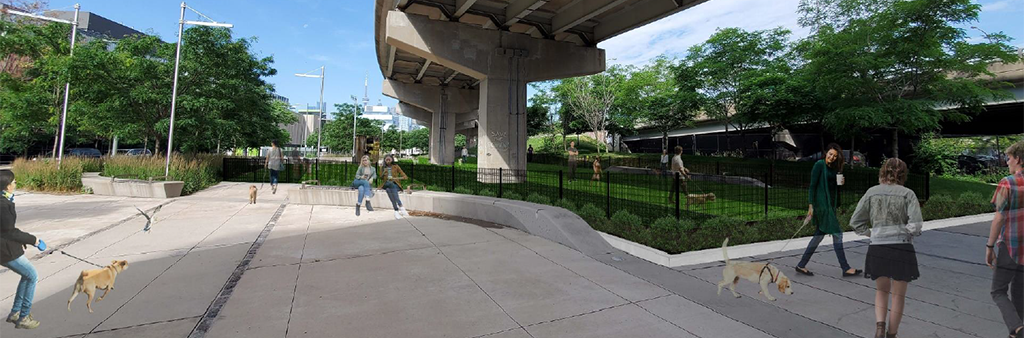 An artist rendering of the dogs off-leash area (OLA) in Underpass Park, which shows an enclosed area for dogs, with grass surrounded by a black fence. The area surrounding the OLA has landscaping and plants and is surrounded by a concrete seatwall and pathways. The OLA is just below an overpass.