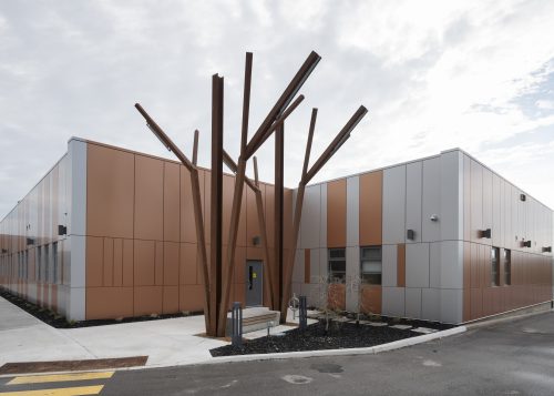 705 Progress Ave. entrance, a low-rise building with a large metal tree-like sculpture in the front