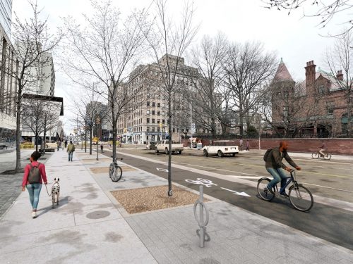 A rendering shows a person cycling in a raised cycle track, between motor vehicle traffic lanes and a wide sidewalk
