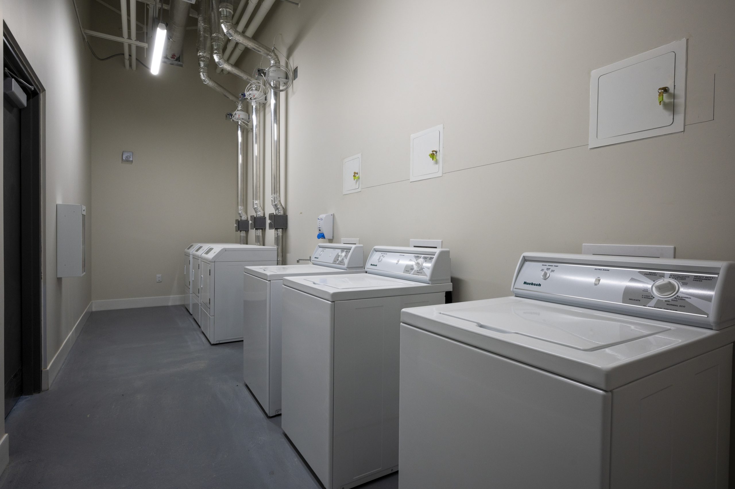 Row of top loading washing machines