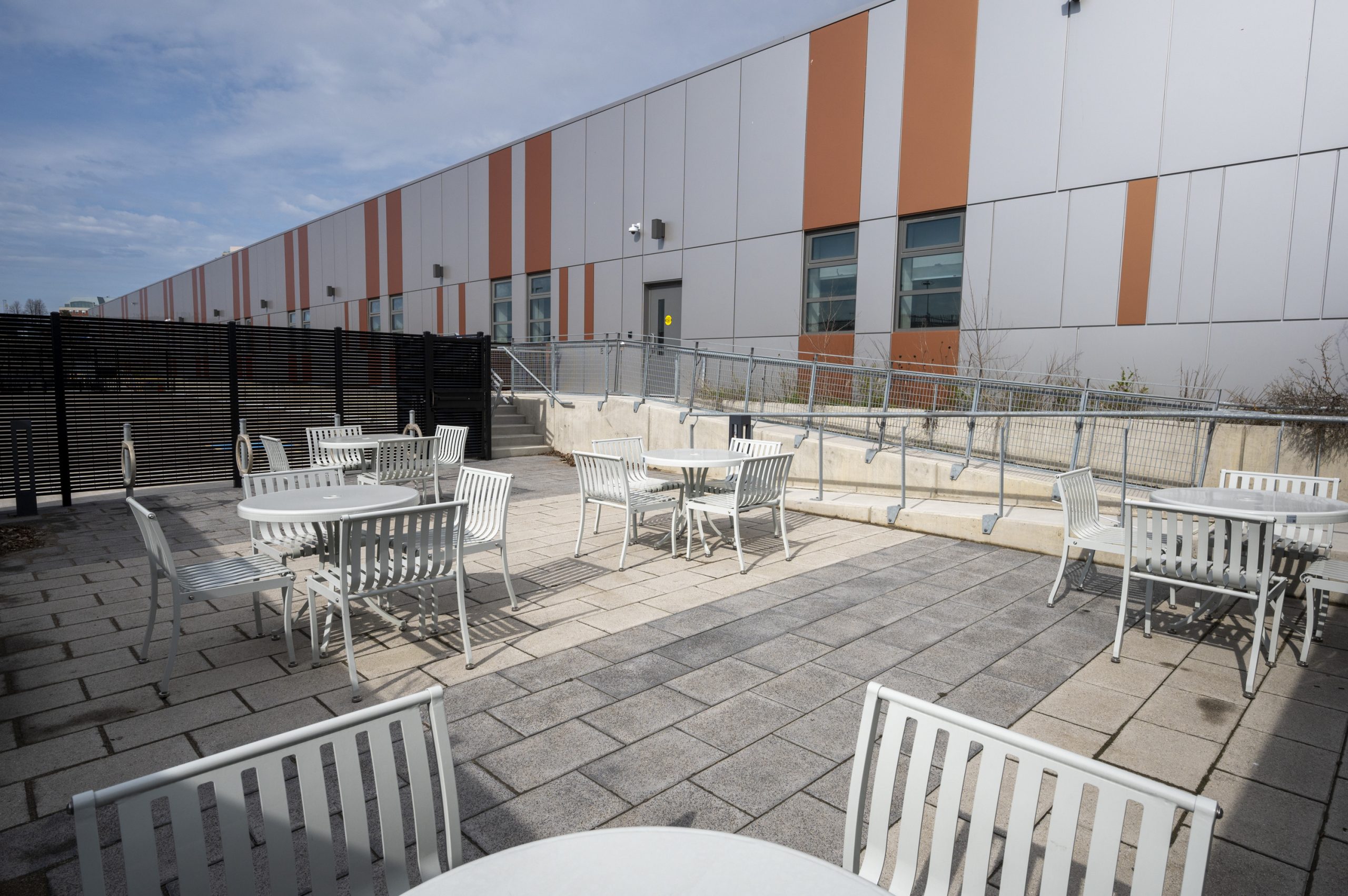 Outdoor patio with interlocking paving stones and white patio furniture