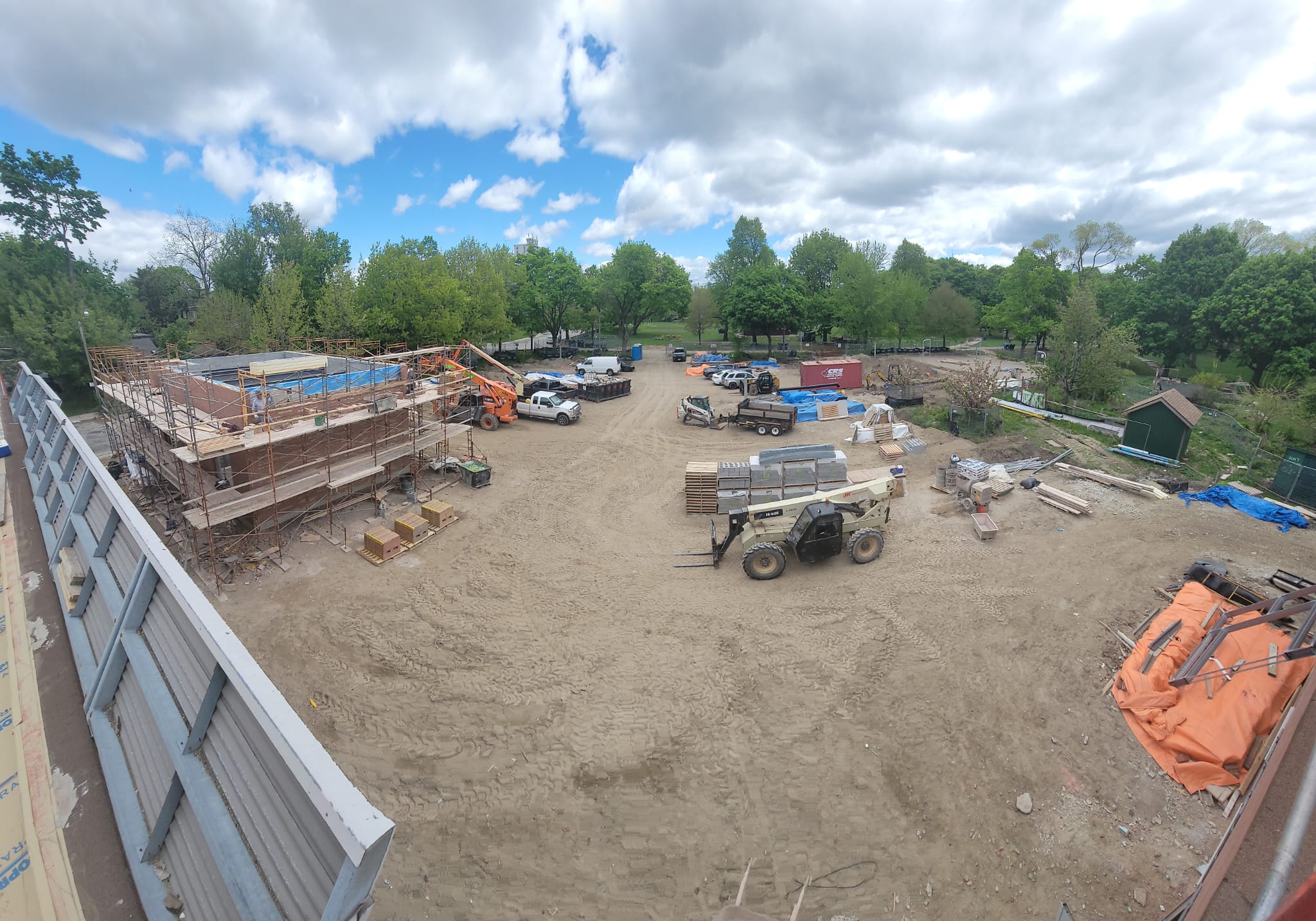 View of the construction site from the roof of the clubhouse, showing the new Zamboni Garage building surrounded by scaffolding.