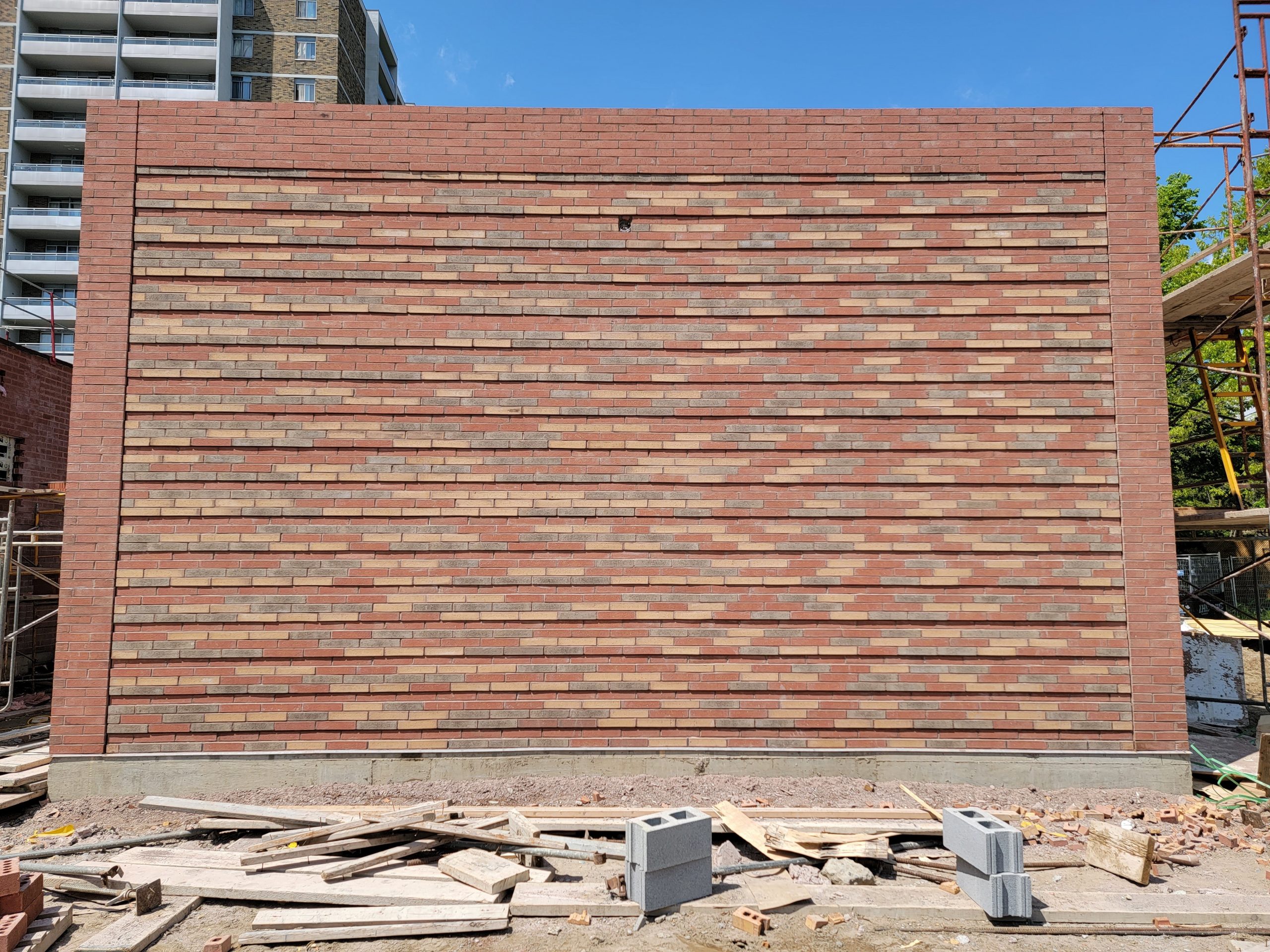 The completed reclaimed brick exterior of the new Zamboni Garage building