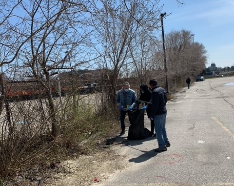 Image of clients at the 1677 Wilson Ave. shelter participating in a community clean up day