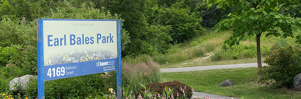 Park sign in a flower bed at Earl Bales Park.