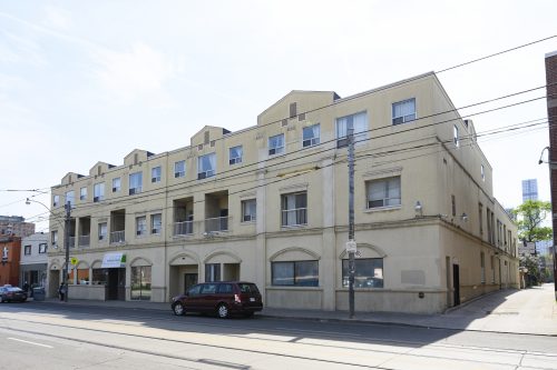 Exterior photo of 292-296 Parliament St. Beige, three-storey building.