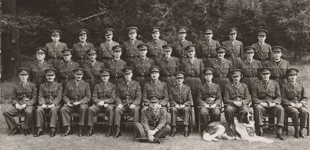 Royal Regiment officers posing with their mascot dog