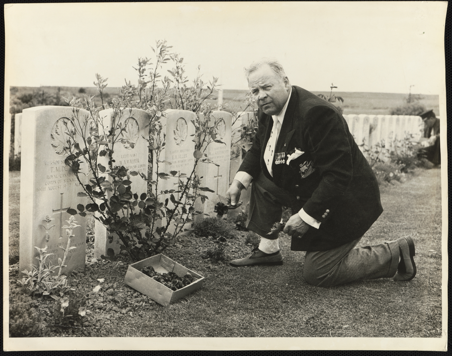 Then Mayor Allan Lamport laying flowers on the graves of Toronto soldiers at the Dieppe Canadian War Cemetery, Hautot-Sur-Mer in France